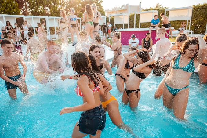Lively daytime pool party crowd
